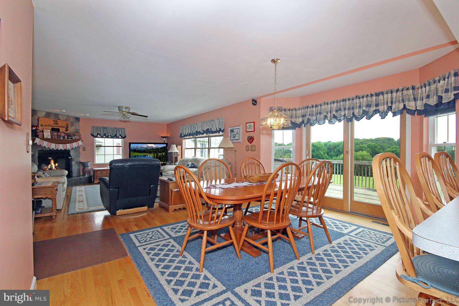 13132 Jesse Smith Road Mount Airy, MD 21771 - Photo 14 of 30 a view of a dining room with furniture window and wooden floor