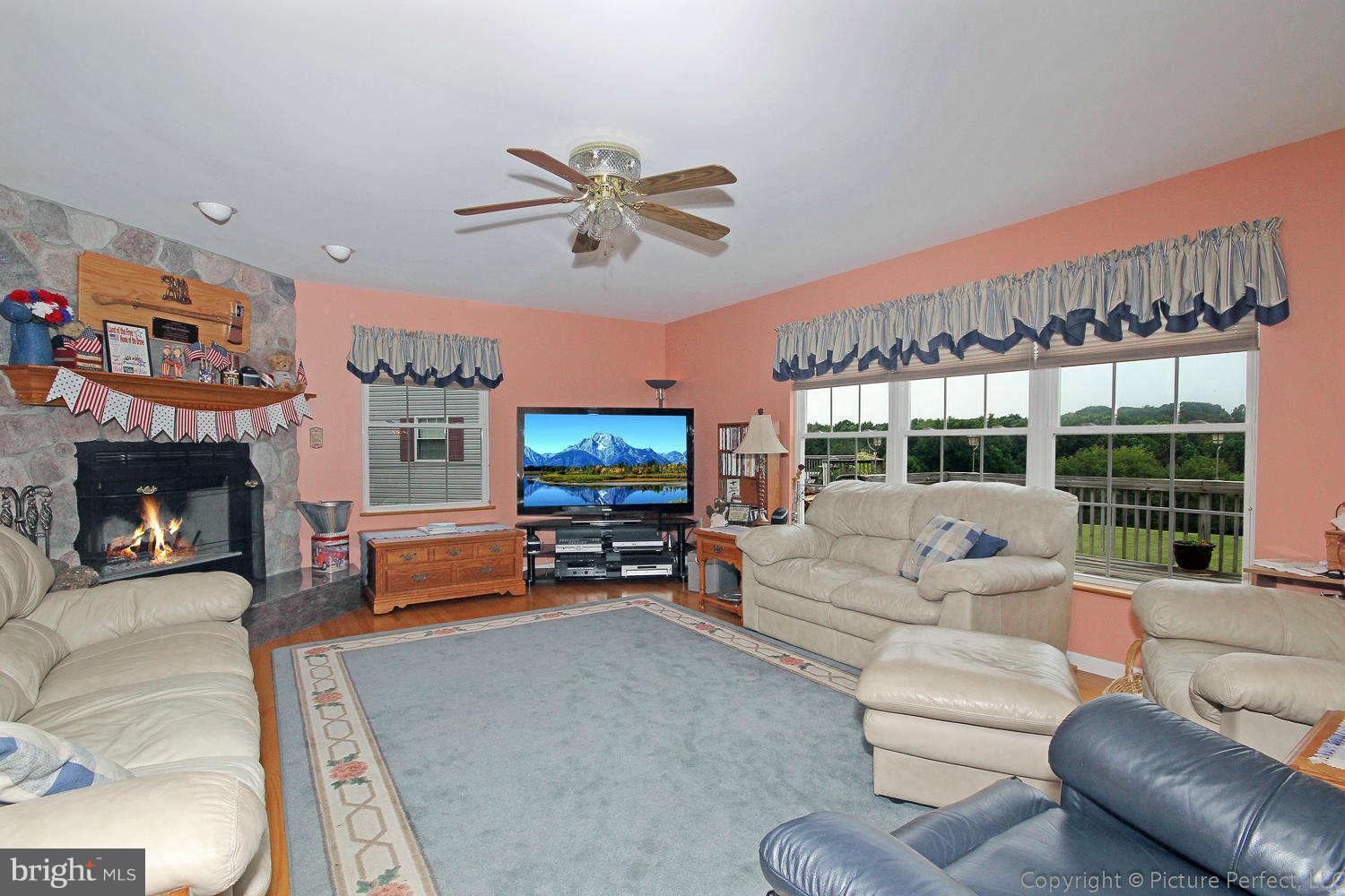 13132 Jesse Smith Road Mount Airy, MD 21771 - Photo 15 of 30 a living room with furniture a fireplace and a flat screen tv