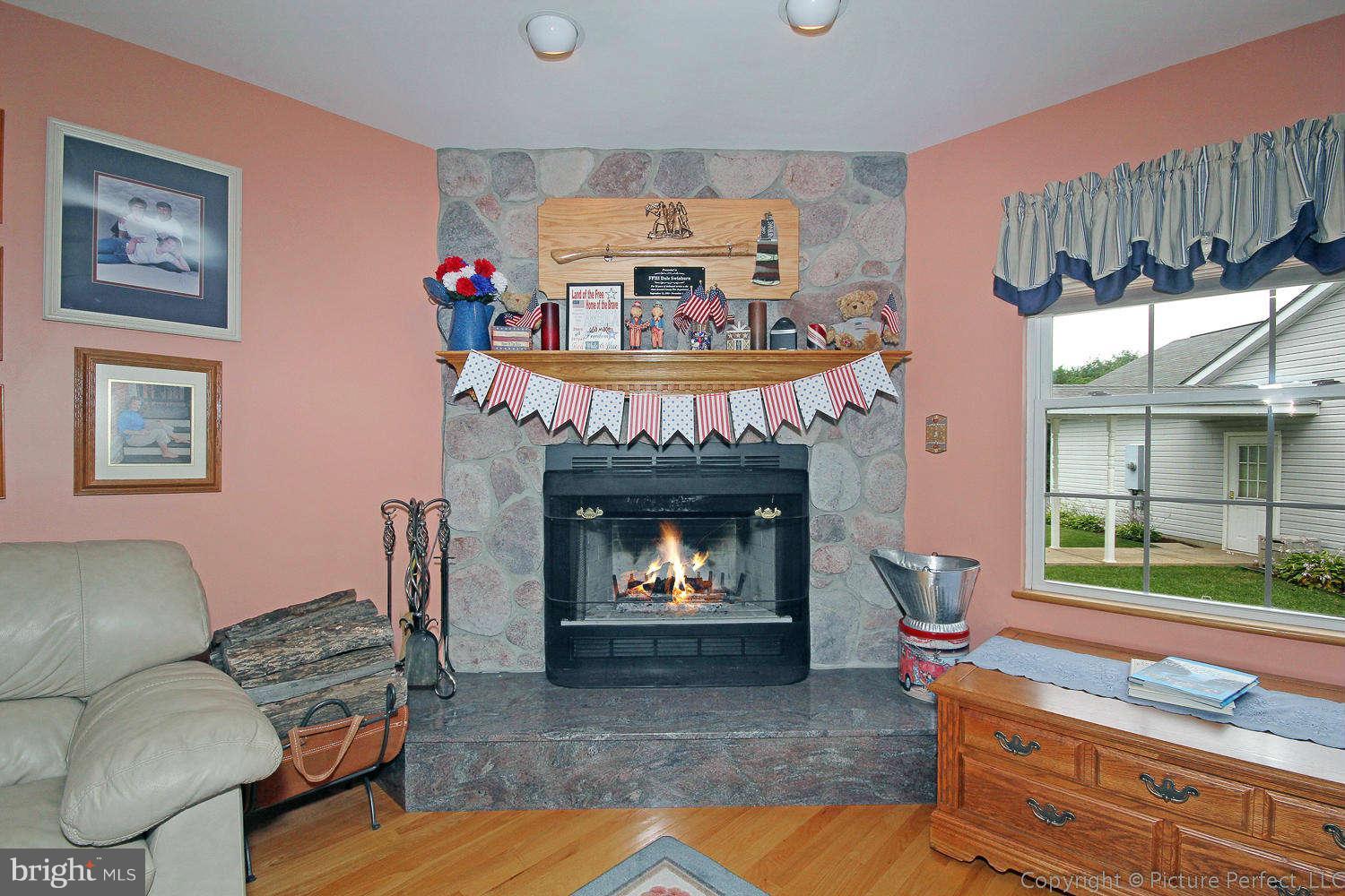 13132 Jesse Smith Road Mount Airy, MD 21771 - Photo 16 of 30 a living room with furniture and a fireplace