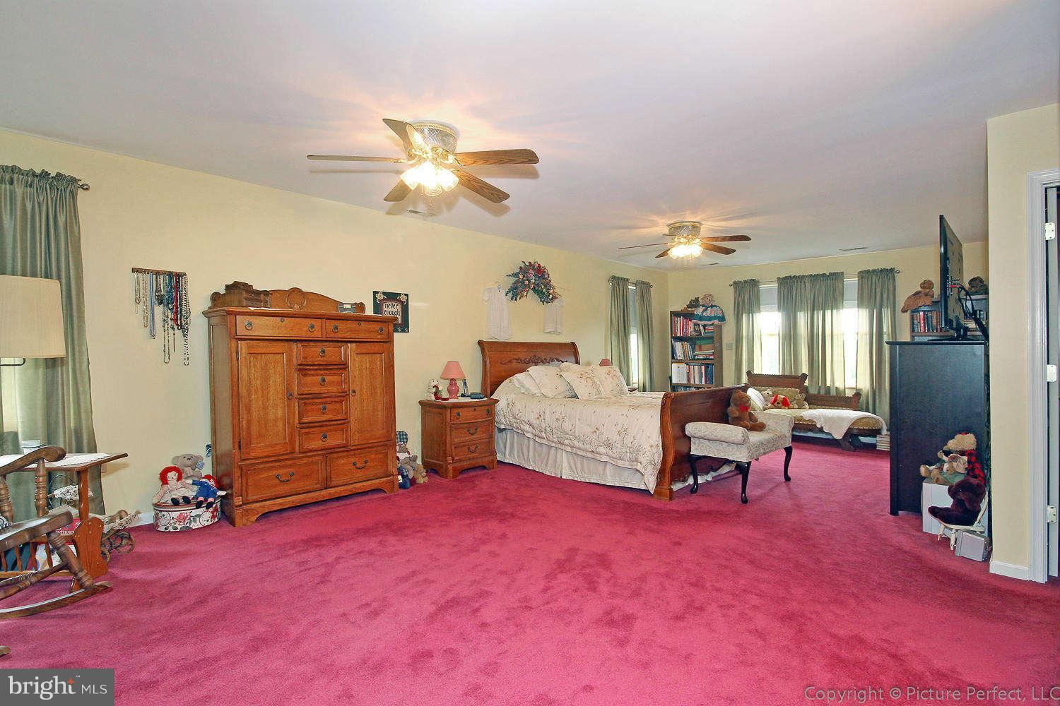 13132 Jesse Smith Road Mount Airy, MD 21771 - Photo 17 of 30 a bedroom with furniture and a chandelier