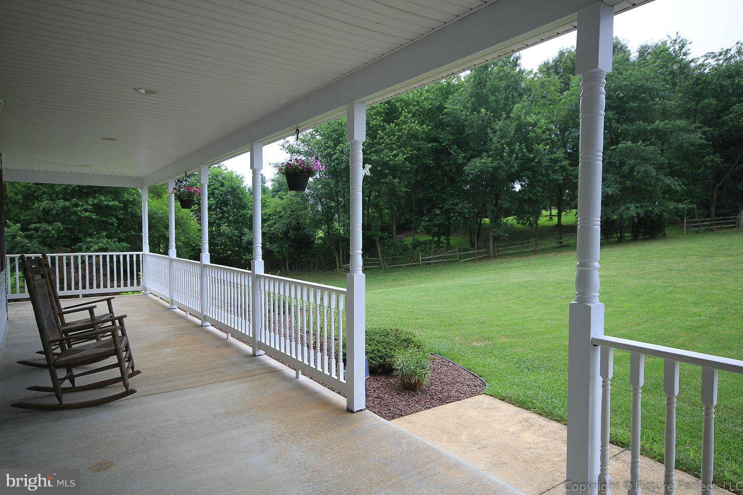 13132 Jesse Smith Road Mount Airy, MD 21771 - Photo 19 of 30 a view of a chair and tables in the porch