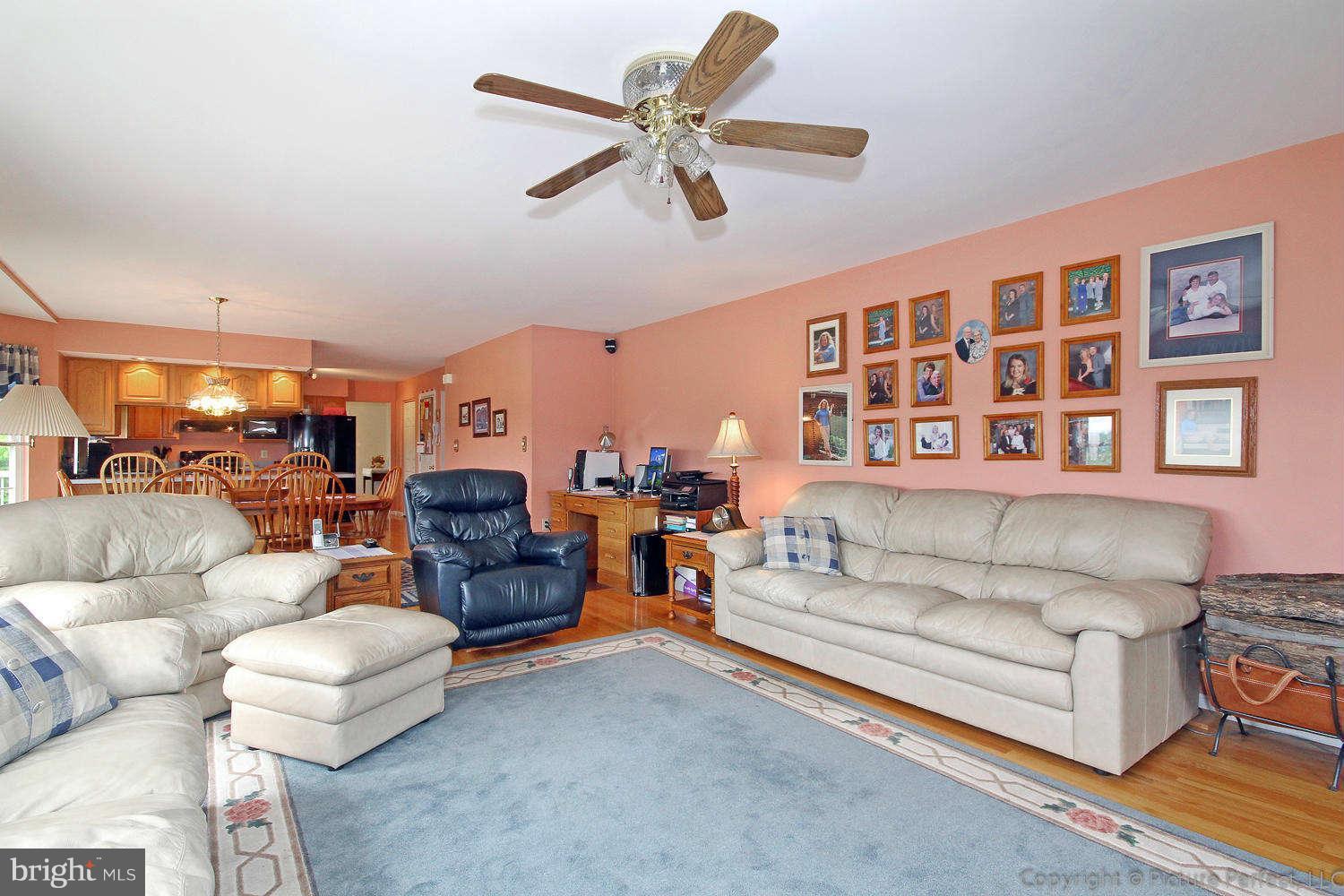 13132 Jesse Smith Road Mount Airy, MD 21771 - Photo 7 of 30 a living room with furniture and a chandelier
