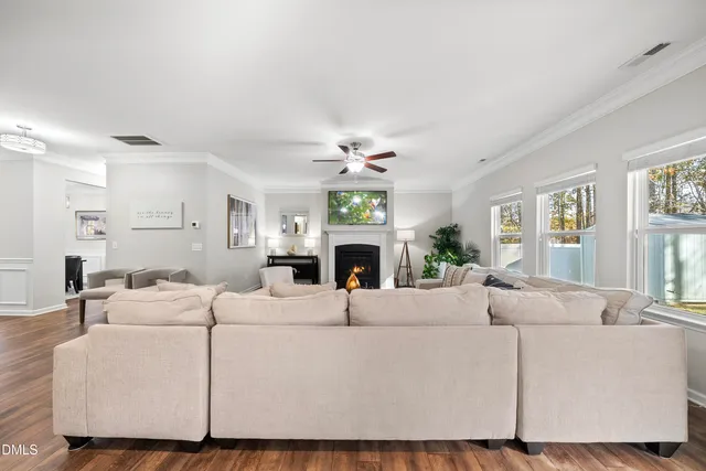 a living room with furniture a fireplace and a window