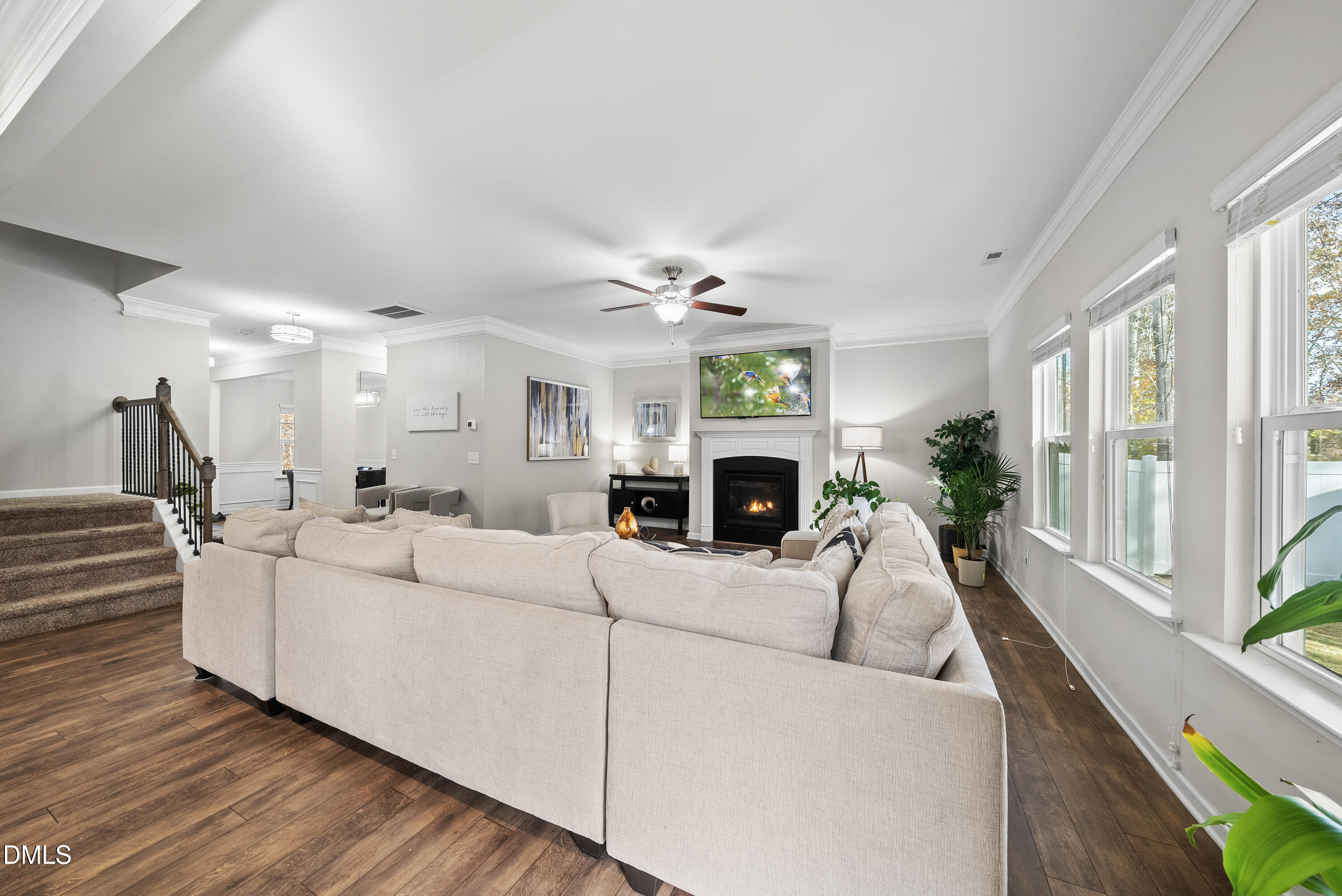 306 Springhill Lane Garner, NC 27529 - Photo 11 of 43 a living room with furniture a large window and a fireplace