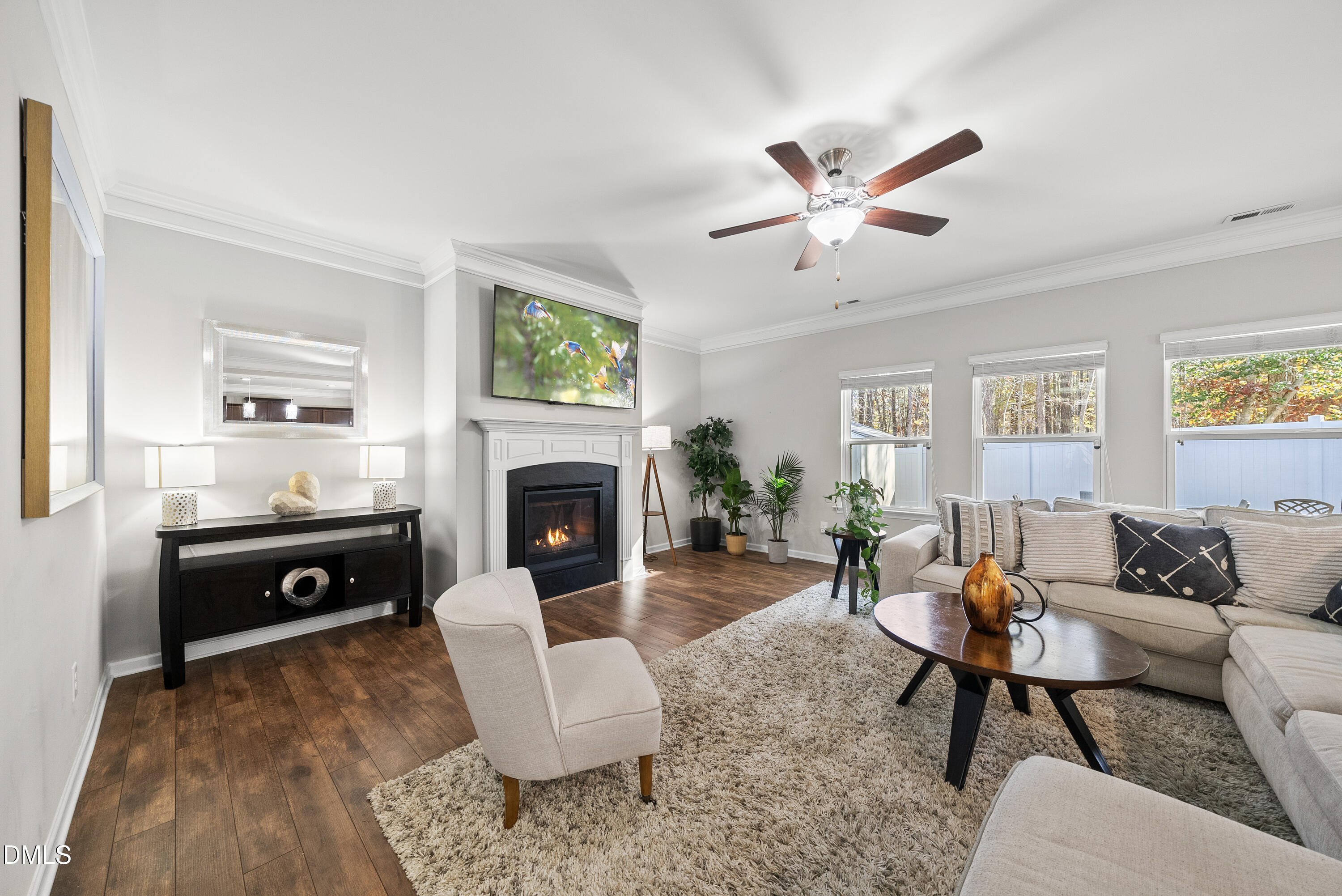 306 Springhill Lane Garner, NC 27529 - Photo 12 of 43 a living room with furniture a fireplace and a flat screen tv
