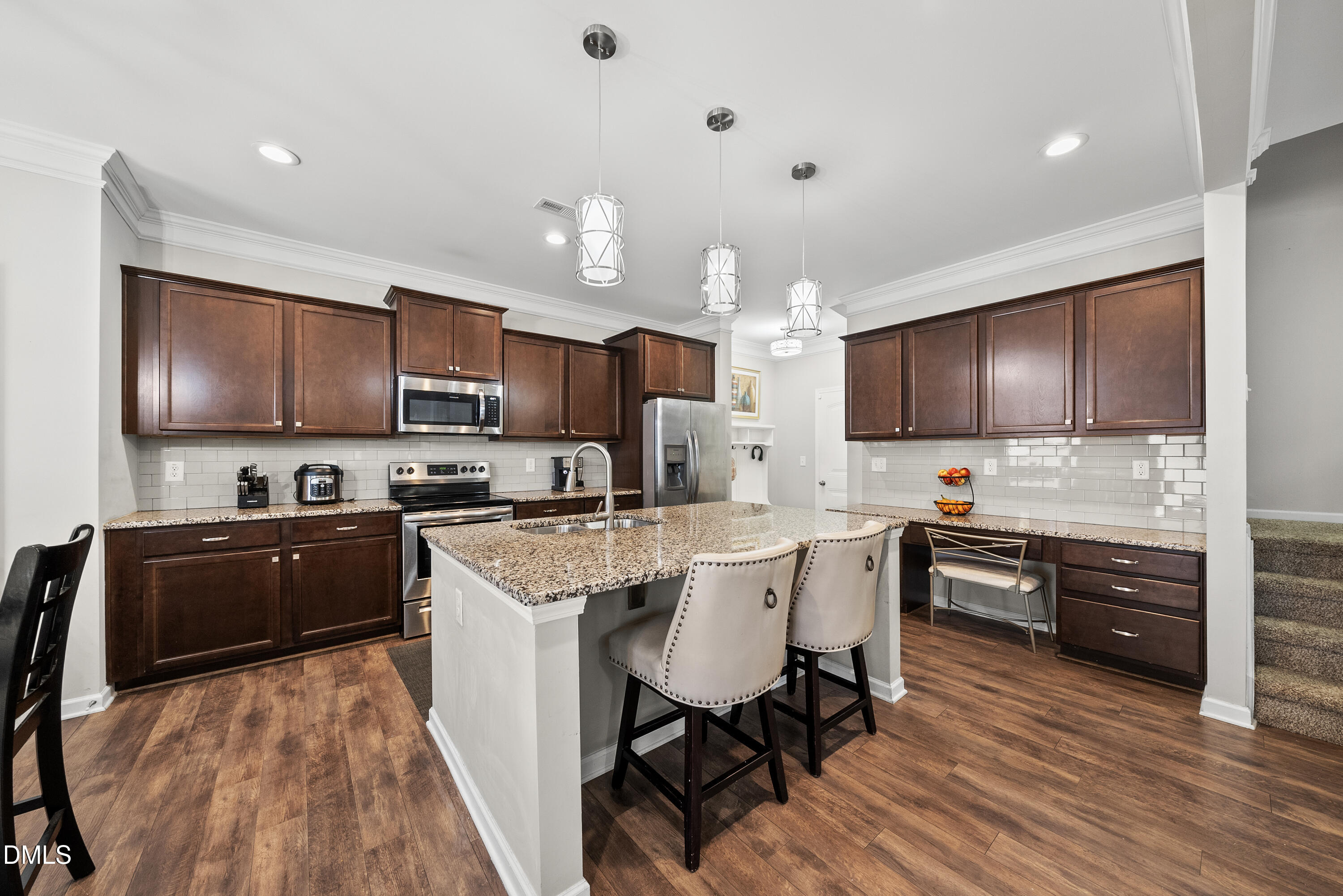 306 Springhill Lane Garner, NC 27529 - Photo 13 of 43 a kitchen with stainless steel appliances a sink a stove a refrigerator cabinets and a dining table