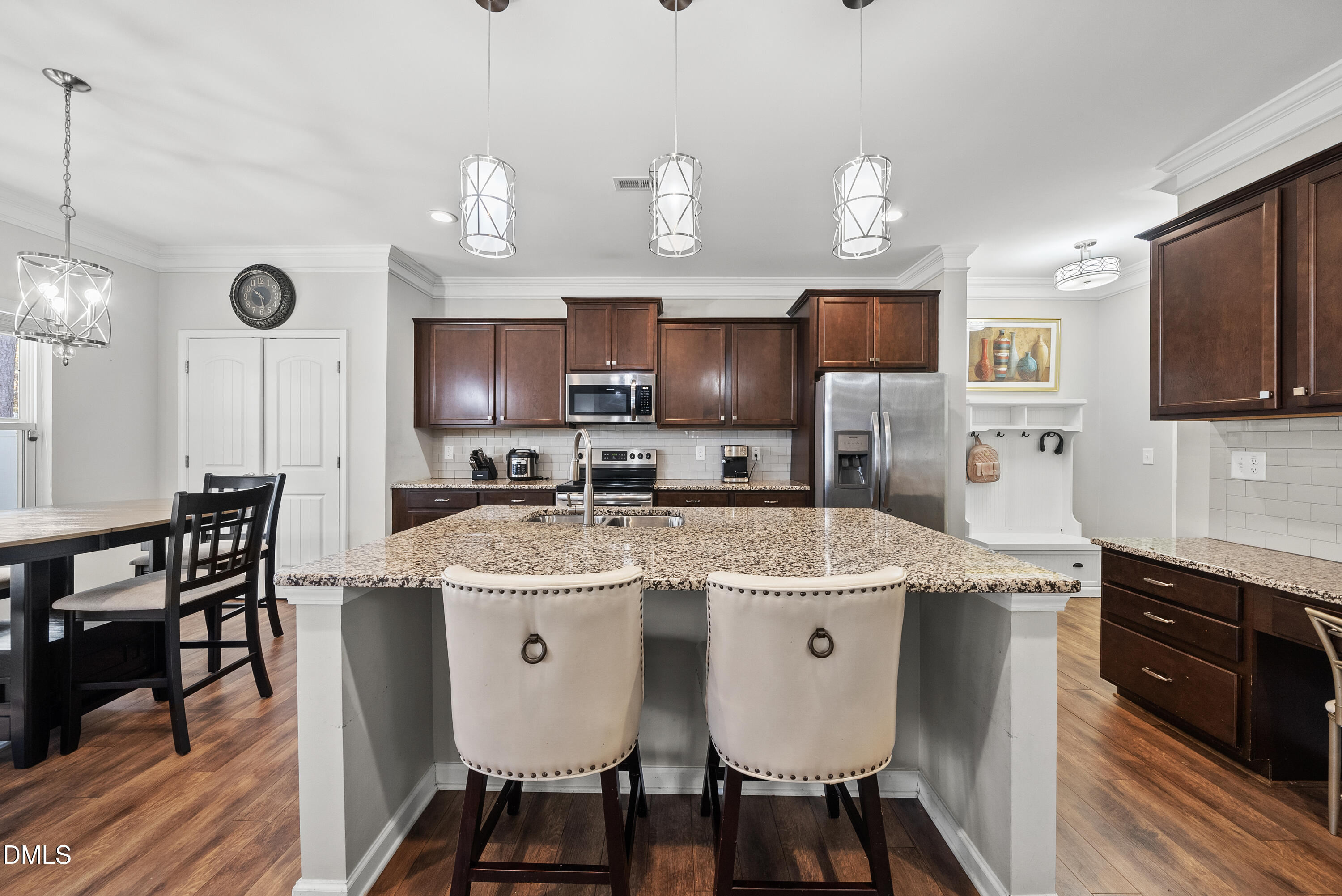 306 Springhill Lane Garner, NC 27529 - Photo 14 of 43 a kitchen with stainless steel appliances granite countertop a sink a stove a refrigerator cabinets and chairs