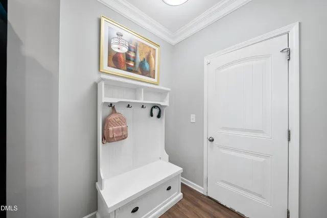 a hallway with painting on the wall and a shower