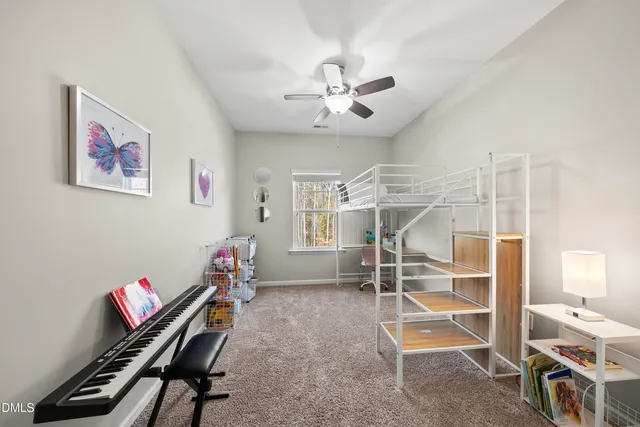 a room with gym equipment and a ceiling fan