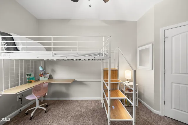 a room with gym equipment and wooden floor