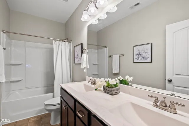a bathroom with a granite countertop sink a toilet and a bathtub