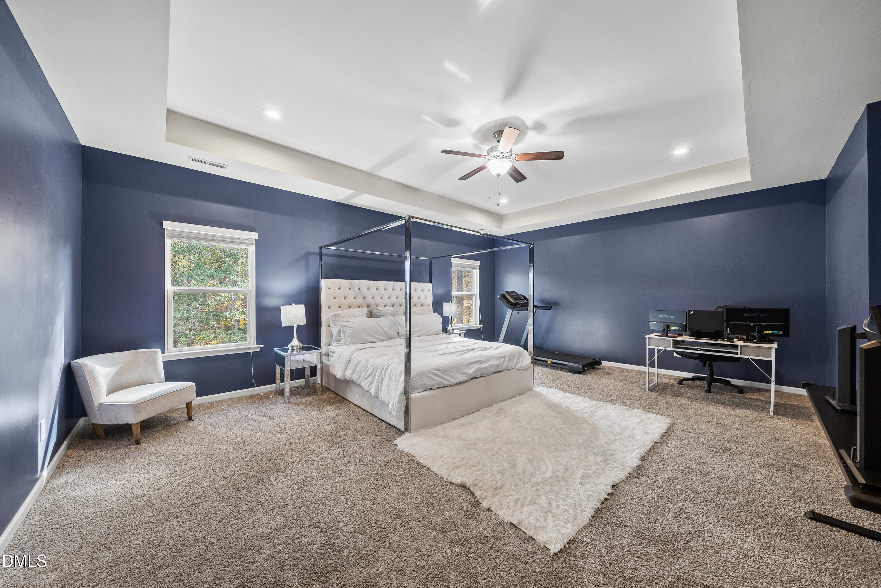 306 Springhill Lane Garner, NC 27529 - Photo 29 of 43 a spacious bedroom with a bed and a chandelier