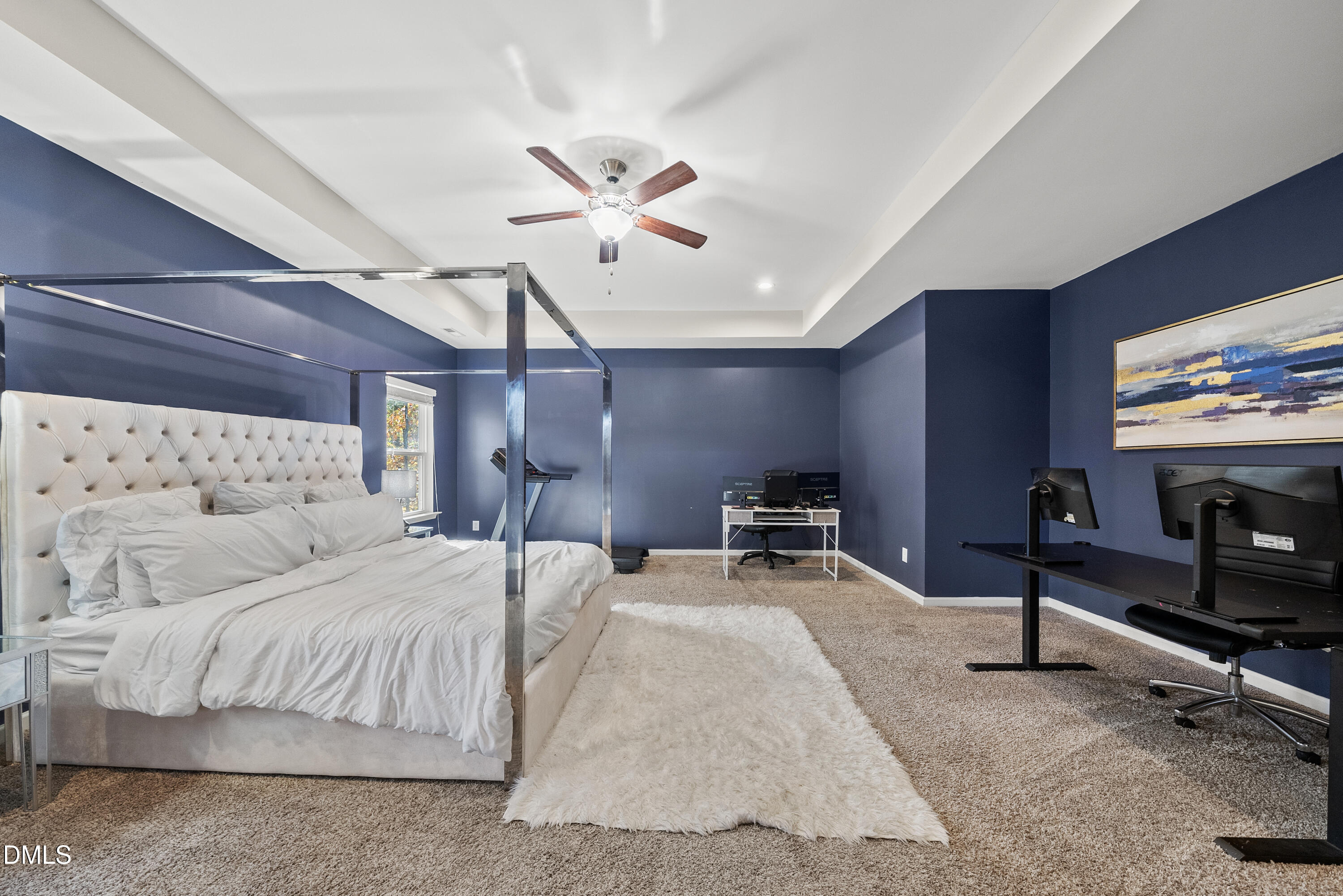 306 Springhill Lane Garner, NC 27529 - Photo 30 of 43 a bedroom with a bed a chandelier and a flat screen tv