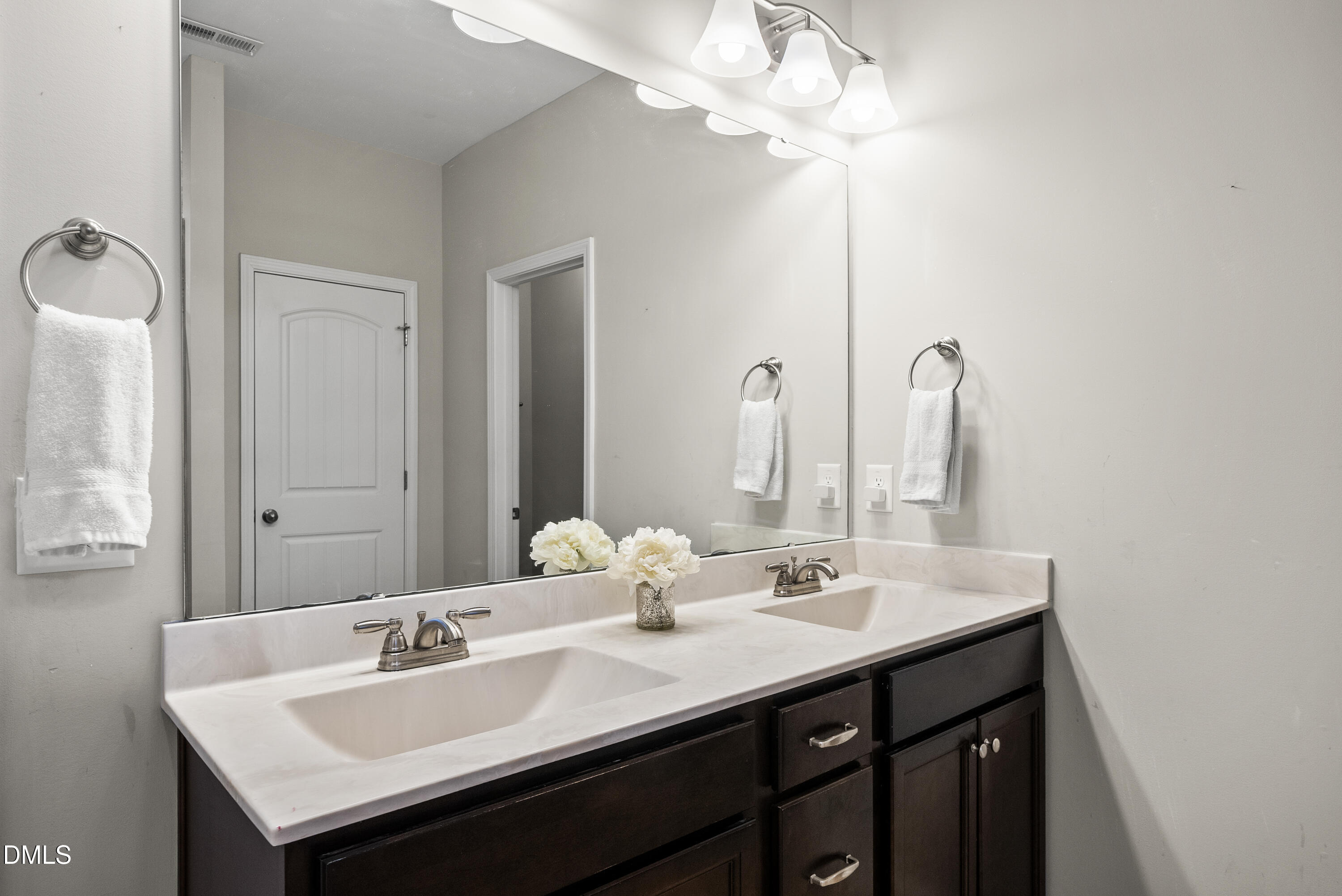 306 Springhill Lane Garner, NC 27529 - Photo 32 of 43 a bathroom with a sink a light fixture and a mirror