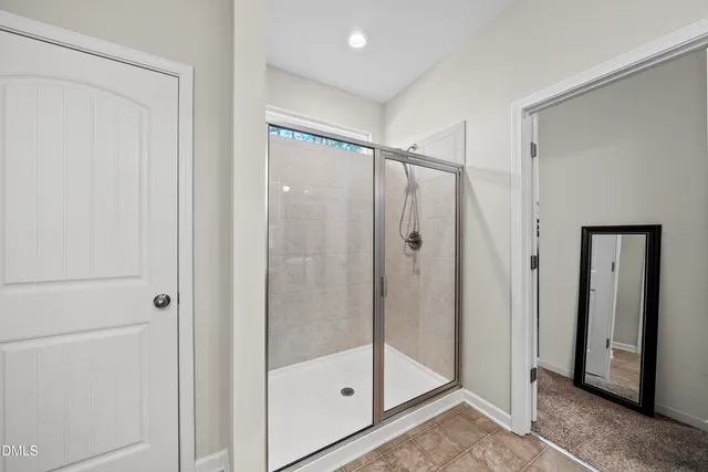 a bathroom with a glass shower door
