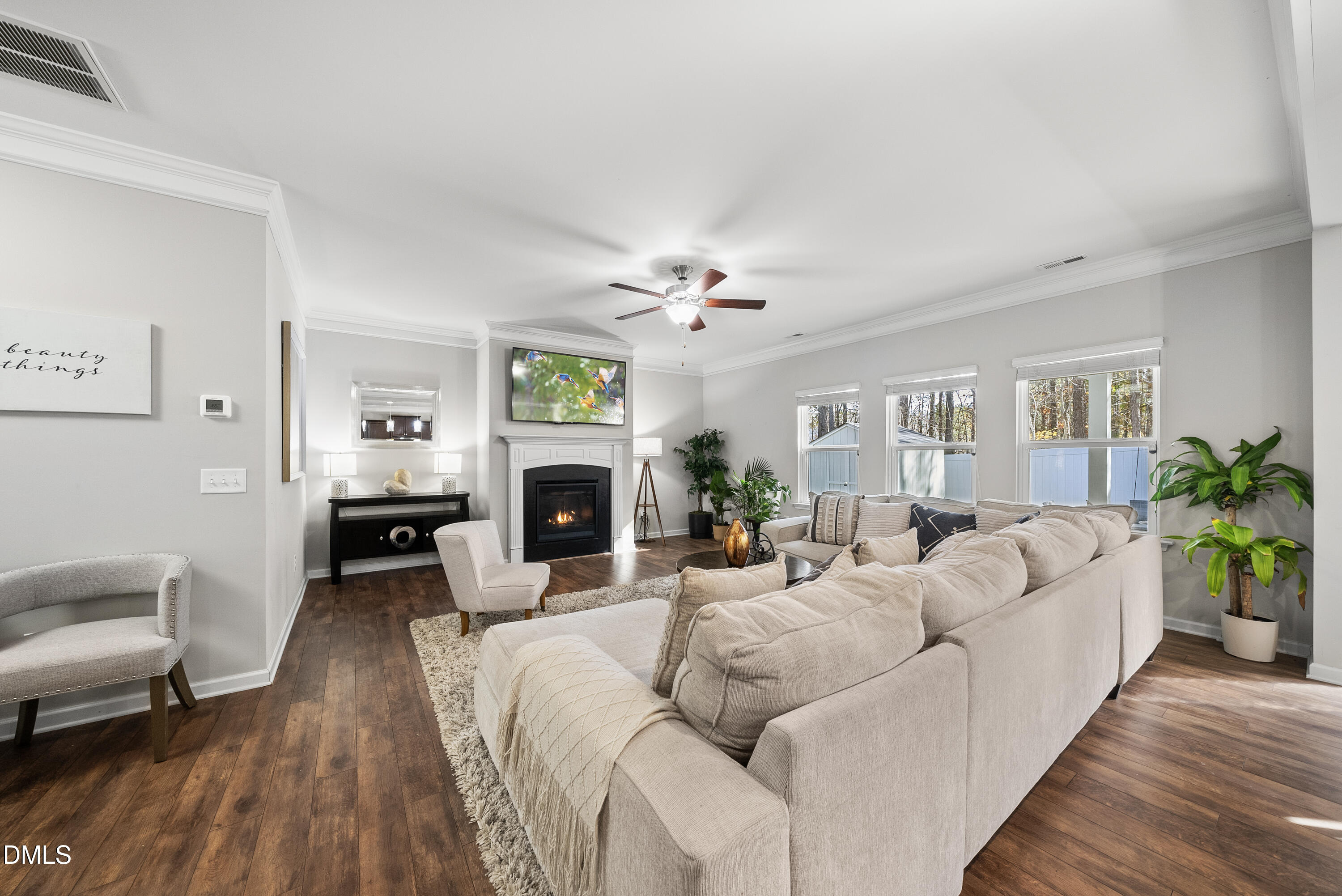306 Springhill Lane Garner, NC 27529 - Photo 9 of 43 a living room with furniture a fireplace and a potted plant