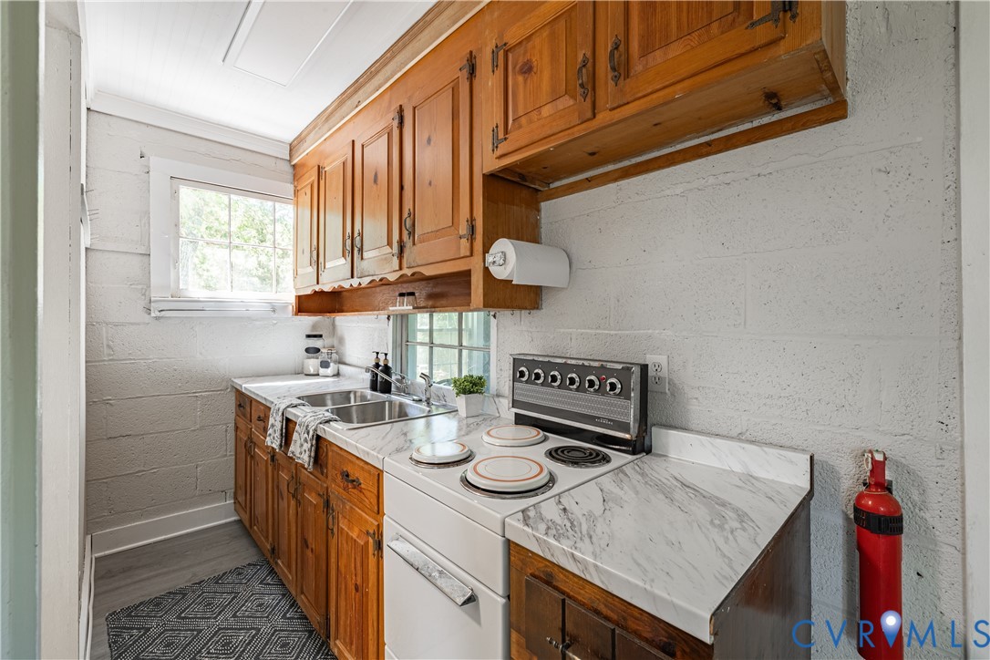 933 Pleasant Point Road Surry, VA 23883 - Photo 9 of 45 a kitchen with stainless steel appliances granite countertop a sink stove and cabinets