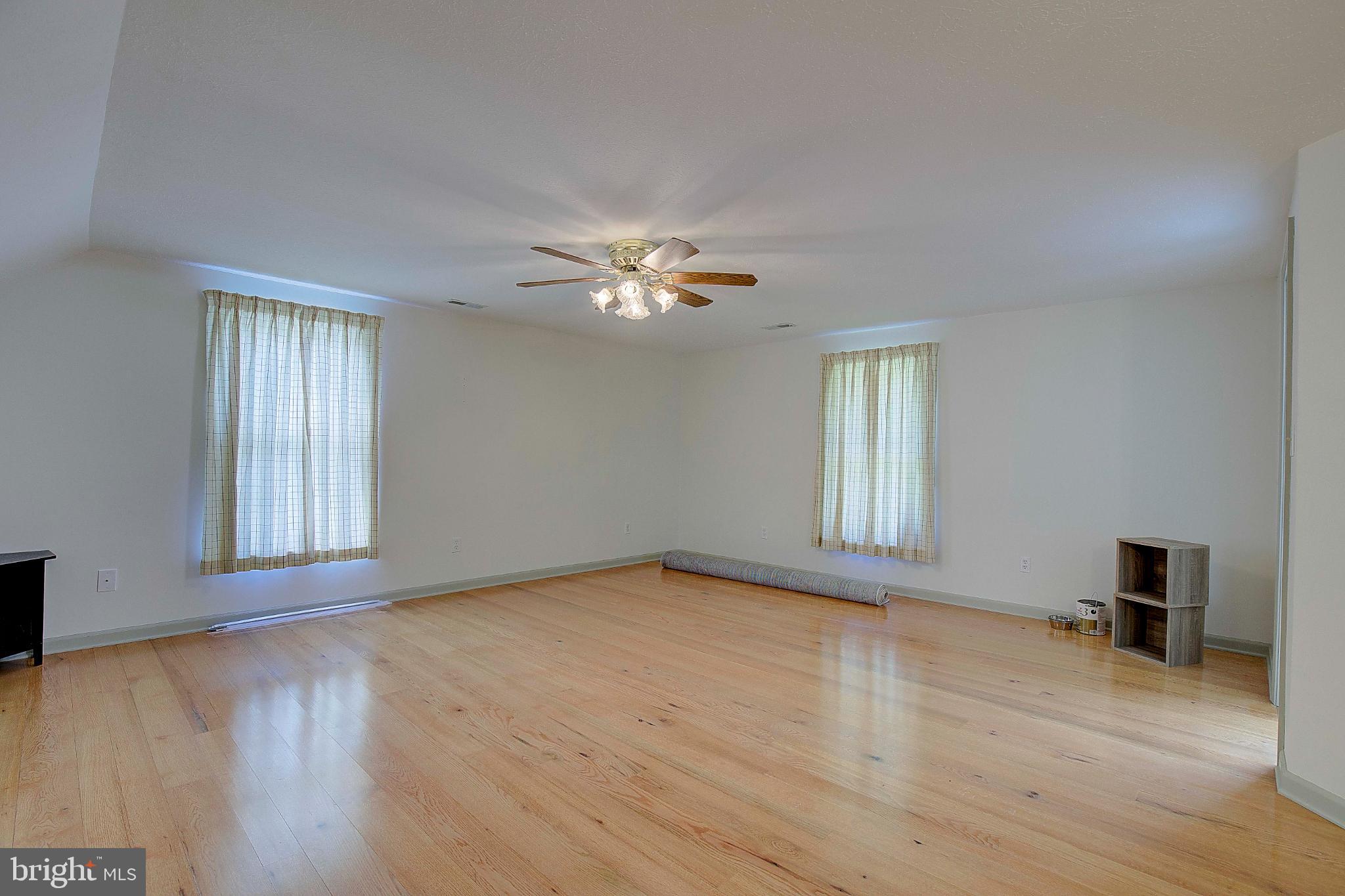 49220 Demko Road Lexington Park, MD 20653 - Photo 28 of 48 a view of an empty room with wooden floor and a window