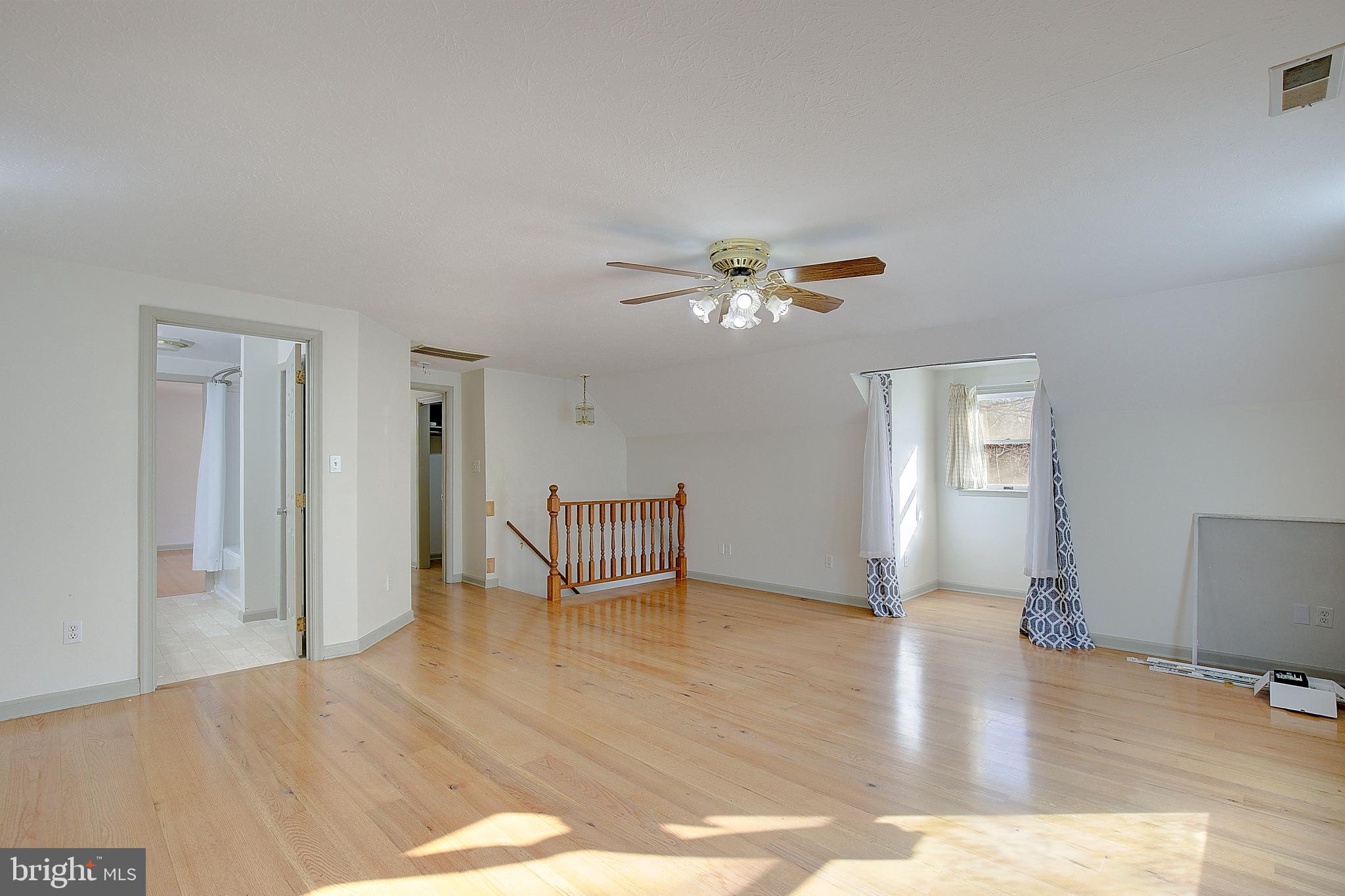 49220 Demko Road Lexington Park, MD 20653 - Photo 35 of 48 a view of an empty room with a window and wooden floor