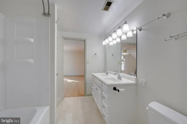 a bathroom with a sink toilet and vanity