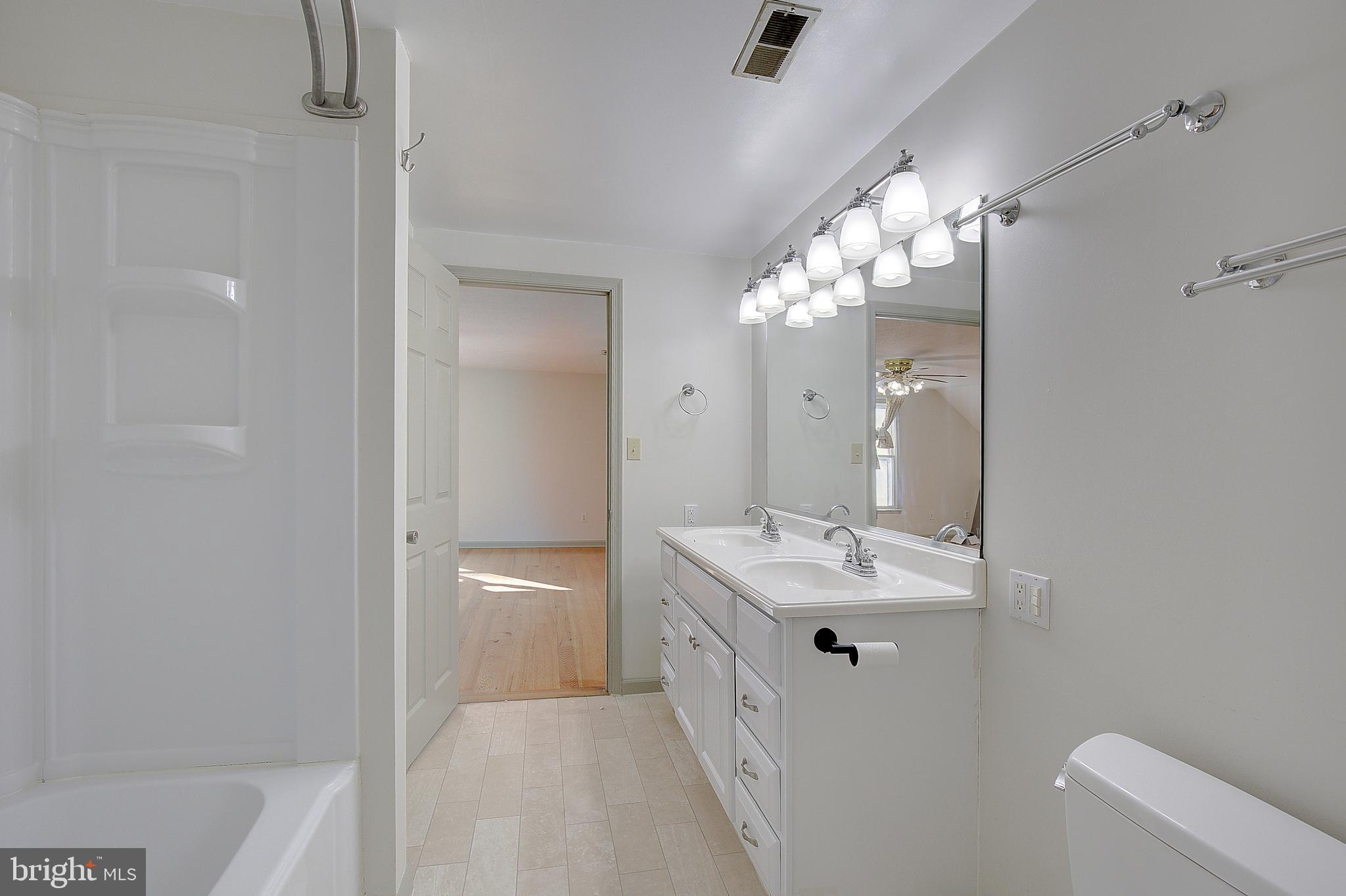 49220 Demko Road Lexington Park, MD 20653 - Photo 41 of 48 a bathroom with a double vanity sink mirror and shower