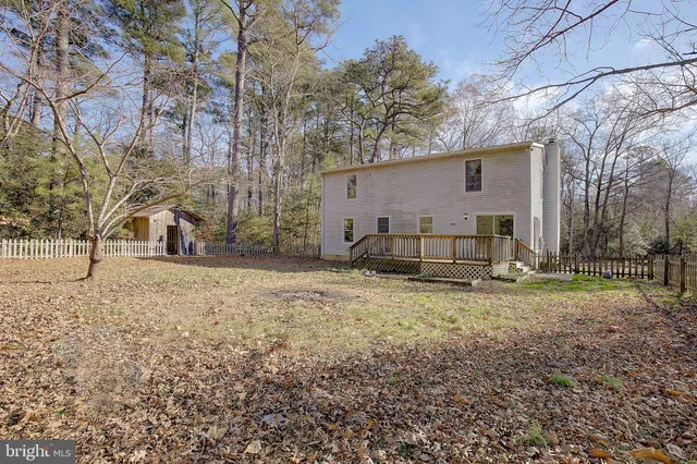 a view of a house with wooden deck