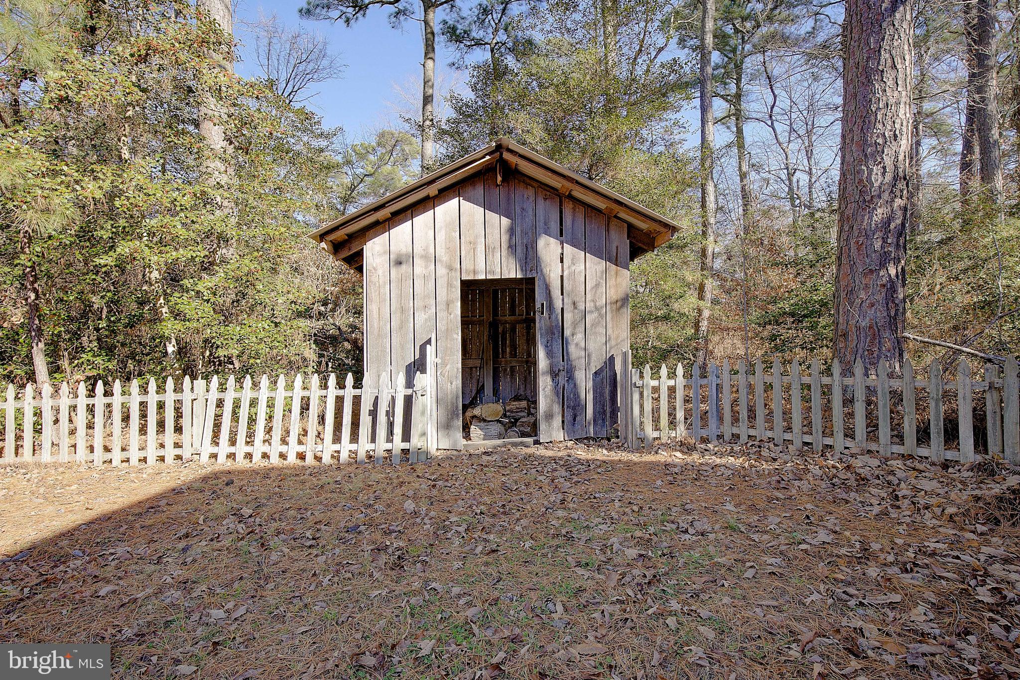 49220 Demko Road Lexington Park, MD 20653 - Photo 48 of 48 a view of a house with wooden fence and large trees