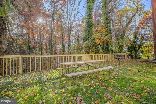 a view of a yard with wooden fence