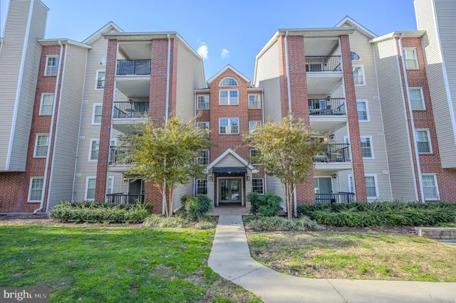 a front view of a residential houses with yard