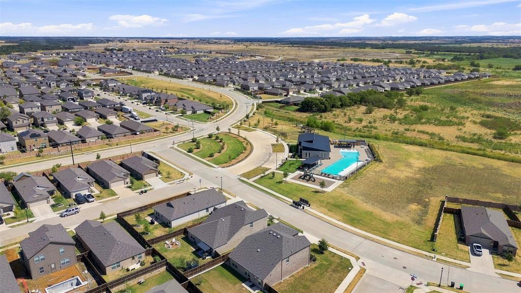 6609 Auburn Dl Road Pilot Point, TX 76258 - Photo 29 of 38 Expansive residential development featuring numerous single-family homes, established street infrastructure, and a community pool with surrounding patio space