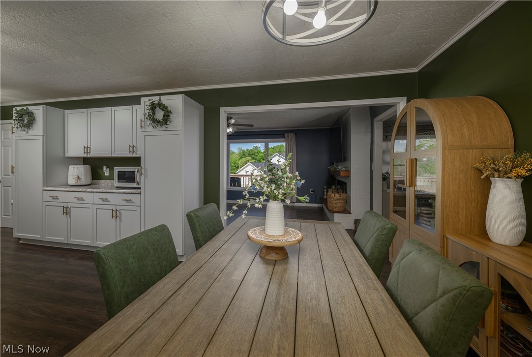 6105 Wolf Run Road Southeast Dennison, OH 44621 - Photo 20 of 35 Spacious dining area featuring dark wood-finish flooring and a contemporary overhead light fixture