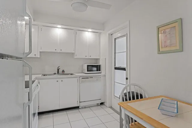 a kitchen with cabinets appliances and a sink