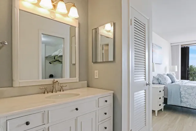 a bedroom with a bed window and a flat screen tv