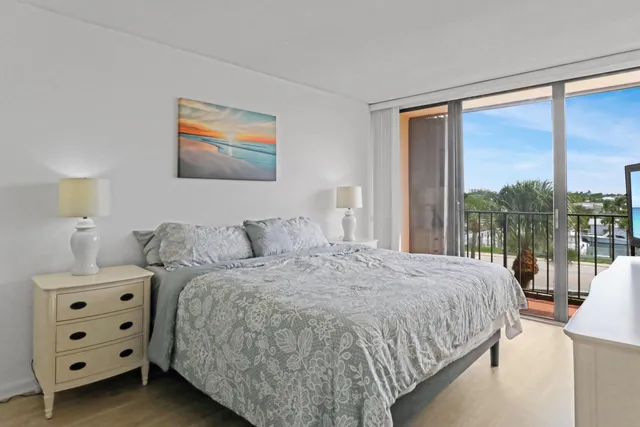 a bedroom with a bed and painting on the wall