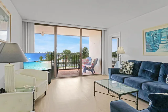 a living room with furniture and a floor to ceiling window