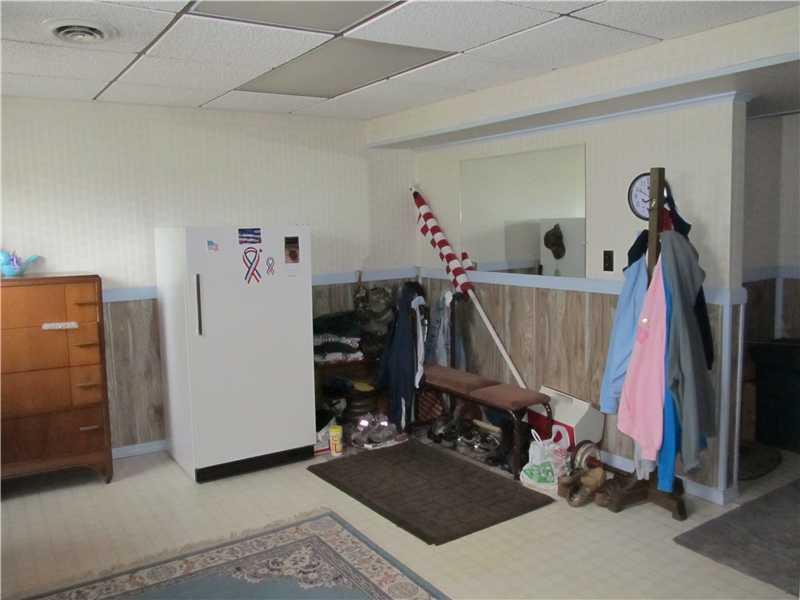 94 Lightcap Road Latrobe, PA 15650 - Photo 23 of 23 Entry/Foyer. This is the entry from the mandoor beside the garage. This room could be an office or simply used for storage. The half bath and laundry room are to the right. And there is so much storage in this house.