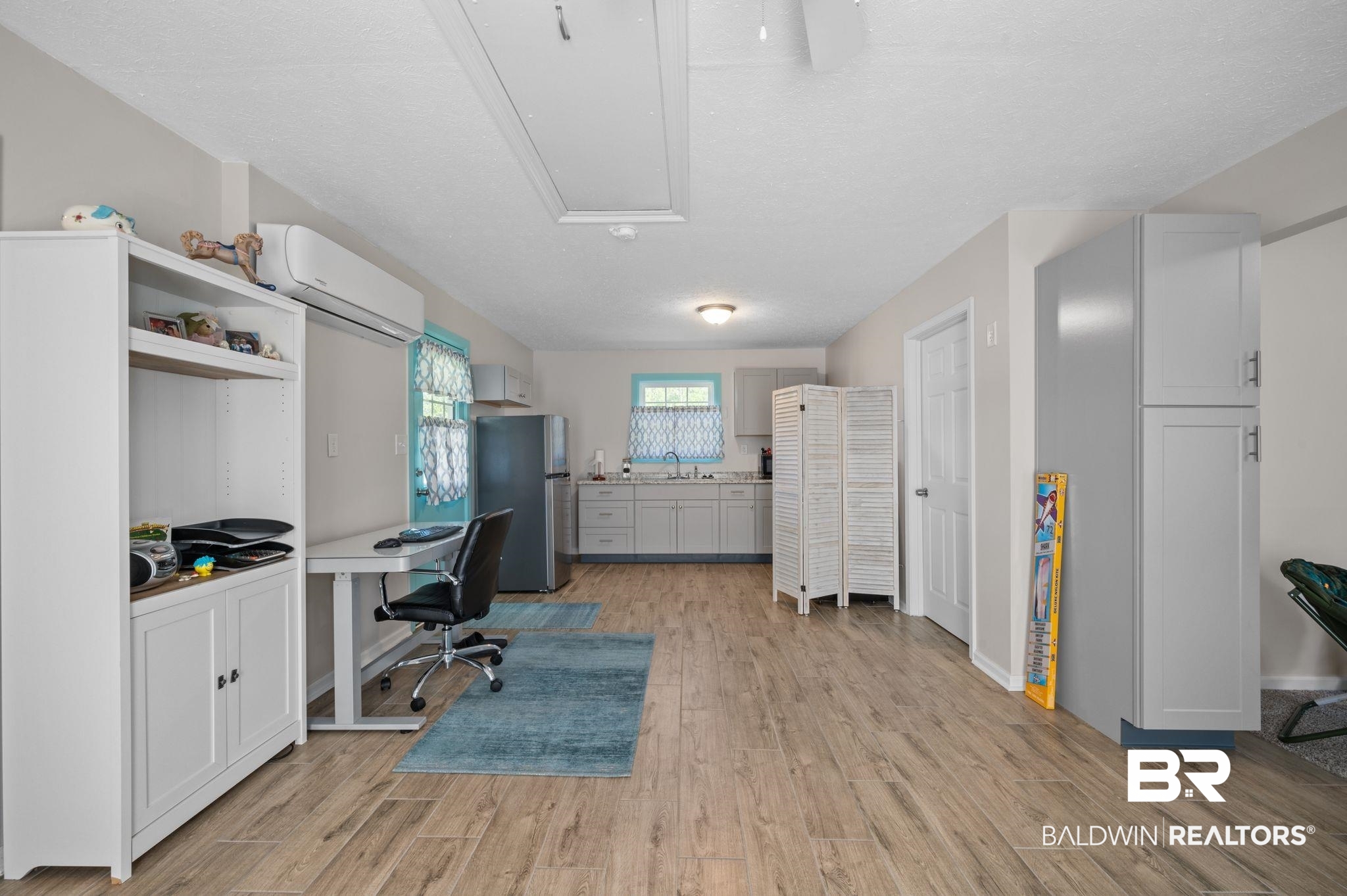48513 Phillipsville Road Bay Minette, AL 36507 - Photo 38 of 50 Office area with light wood-style floors, a wall mounted AC, and attic access