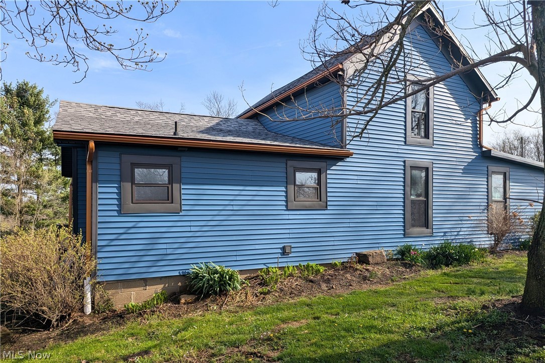 12972 Gilmore Road Southeast Port Washington, OH 43837 - Photo 37 of 50 Rear view of house featuring a shingled roof and a lawn