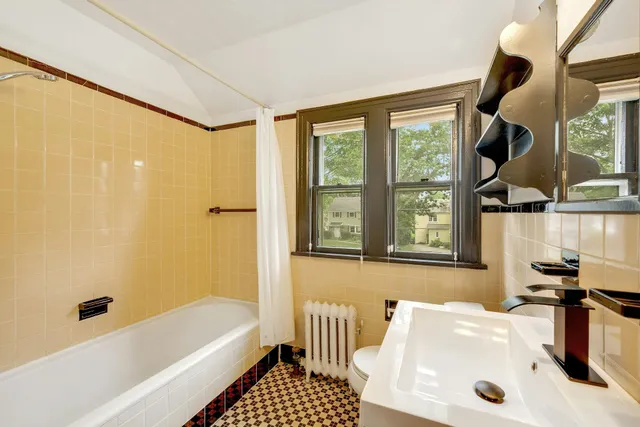 a bathroom with a bathtub and a shower