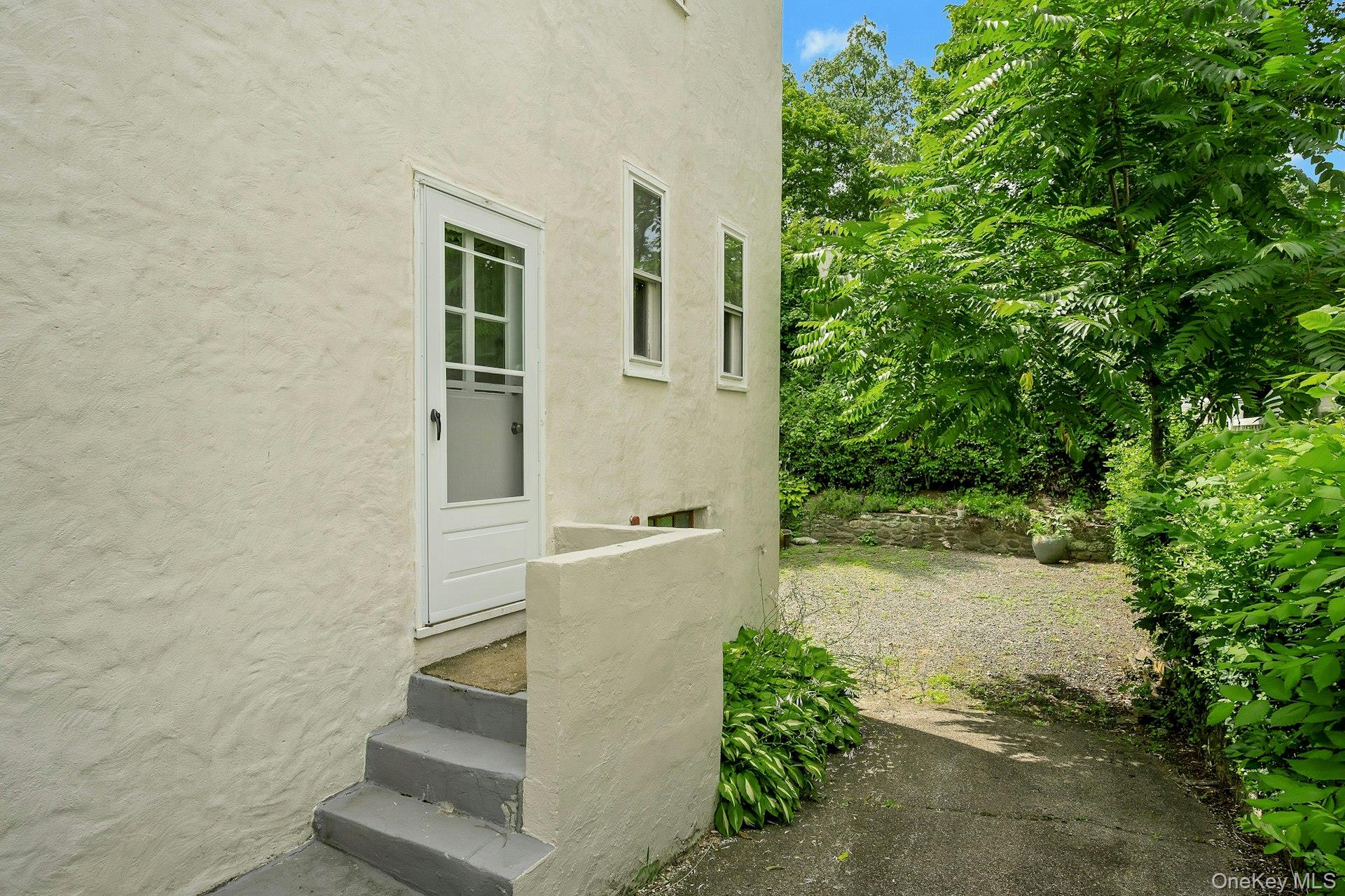 151 Clarence Road Scarsdale, NY 10583 - Photo 19 of 28 a view of a house with a yard