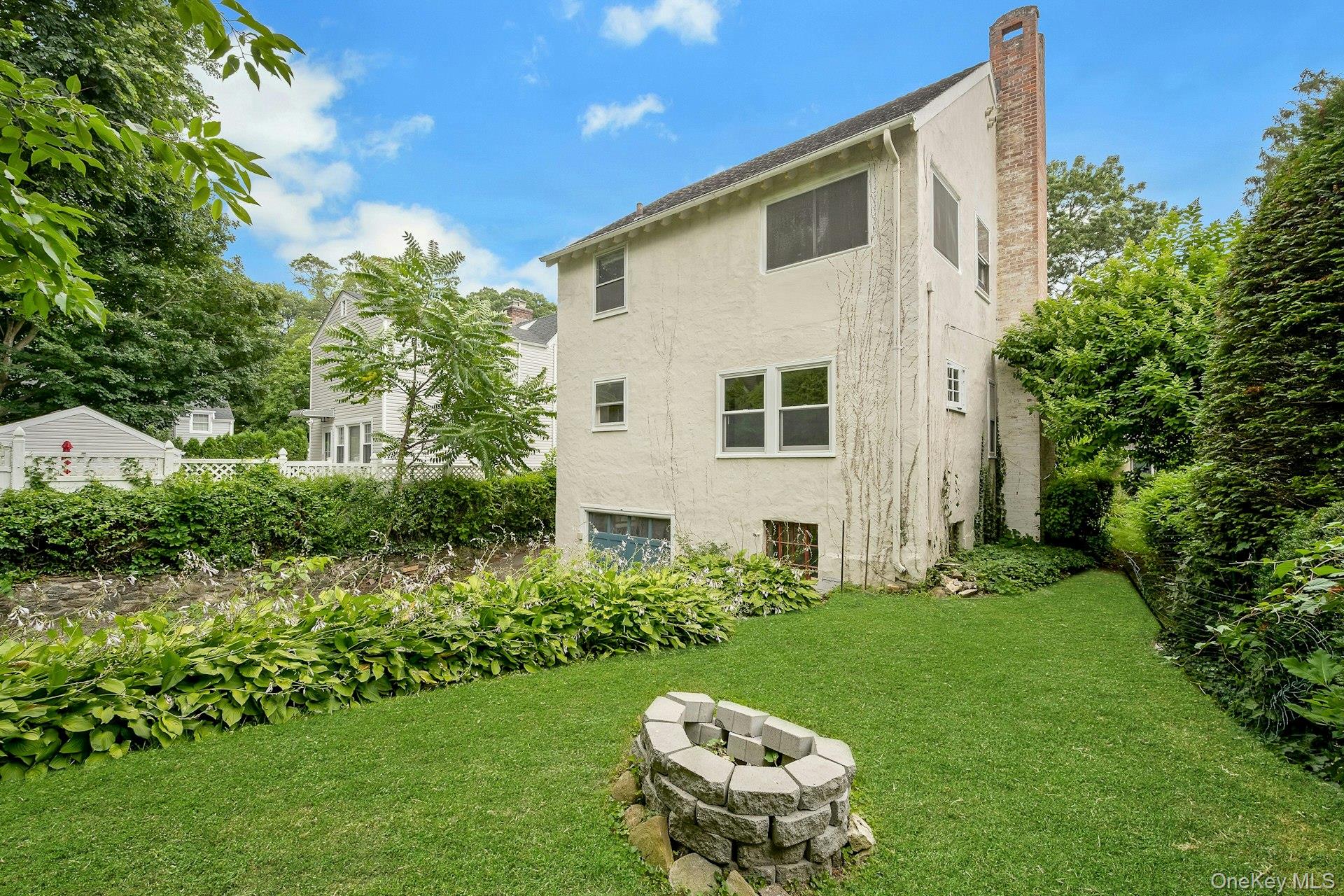 151 Clarence Road Scarsdale, NY 10583 - Photo 22 of 28 a view of a small house with a yard