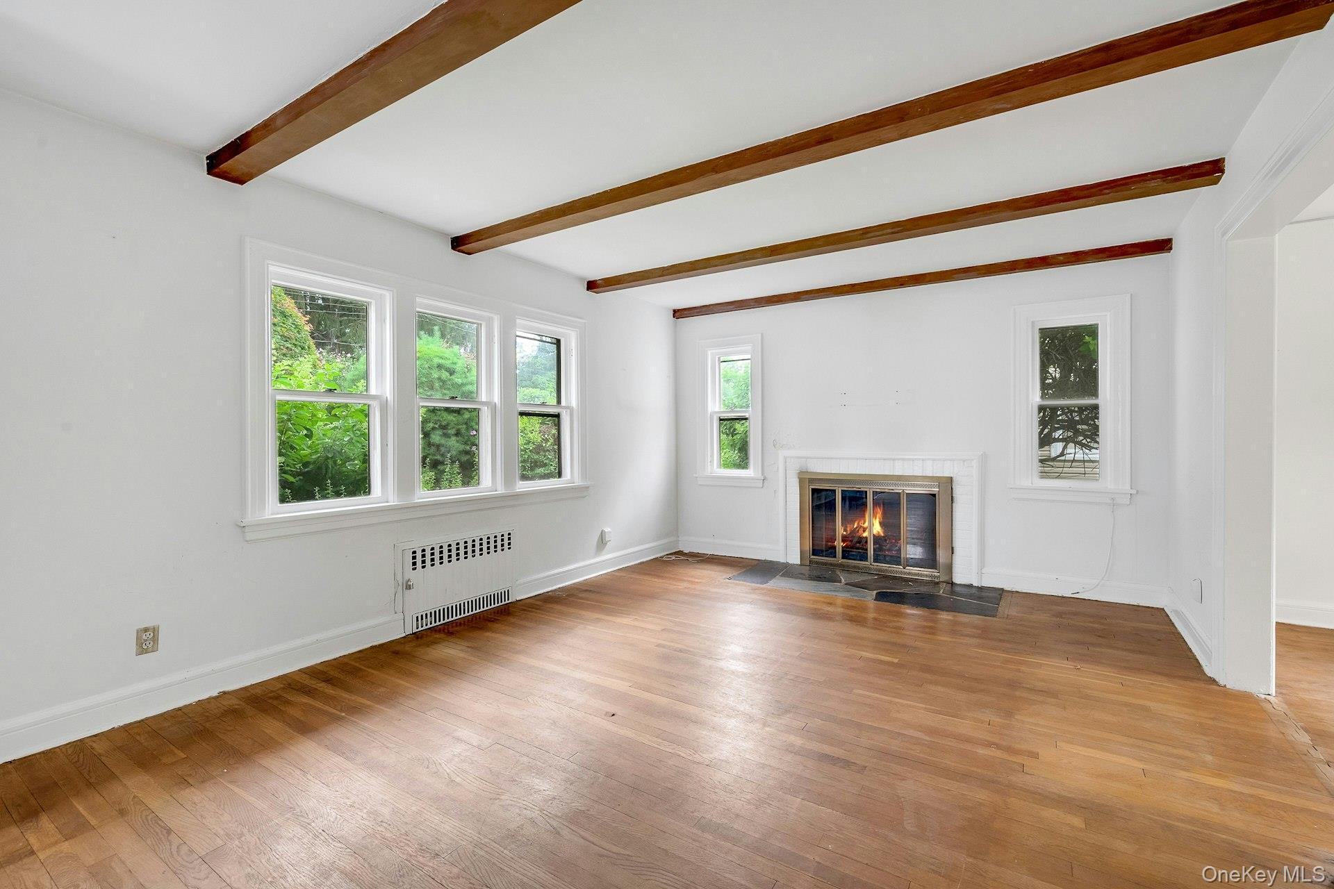 151 Clarence Road Scarsdale, NY 10583 - Photo 4 of 28 a view of an empty room with window and fire place