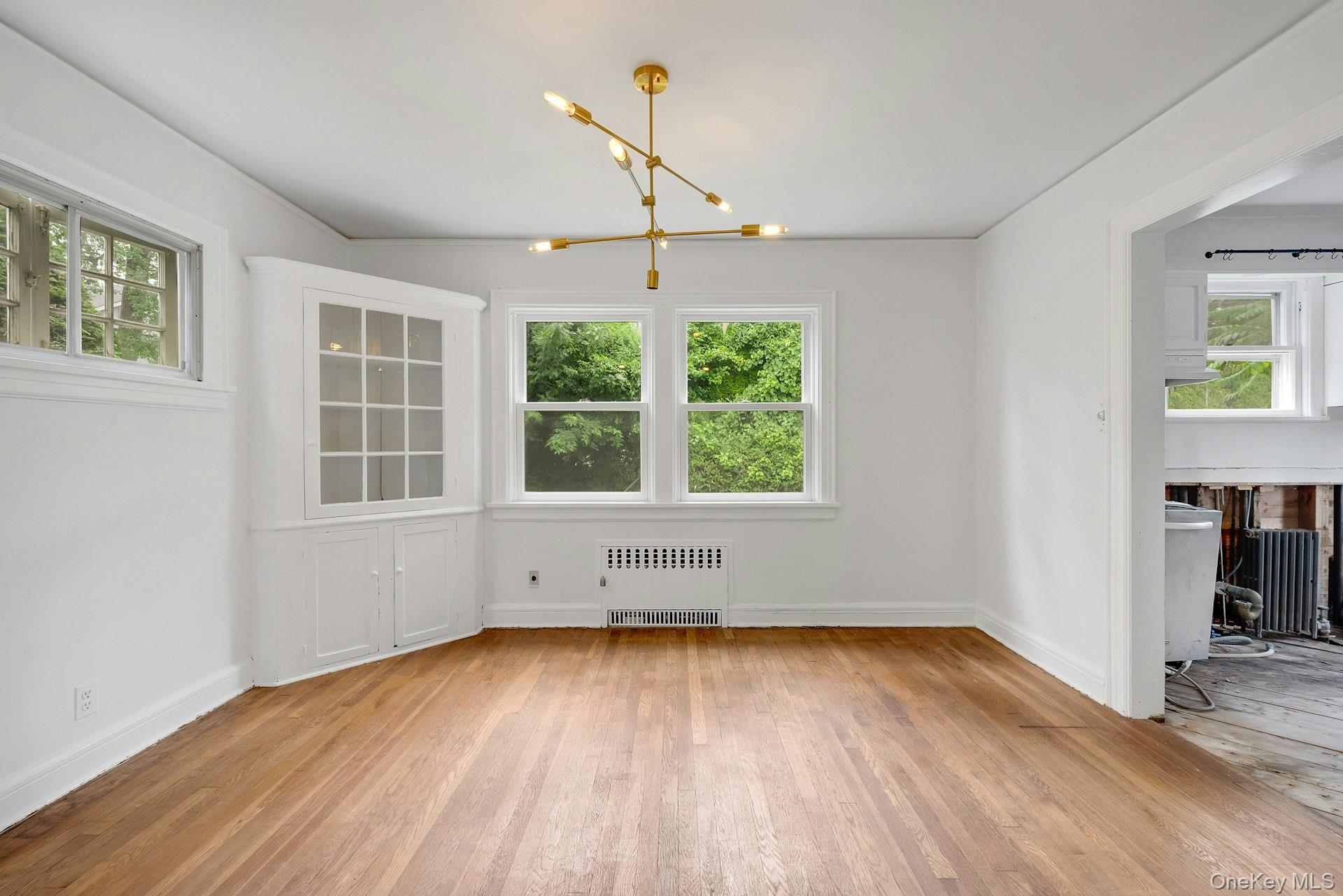 151 Clarence Road Scarsdale, NY 10583 - Photo 7 of 28 an empty room with wooden floor and windows