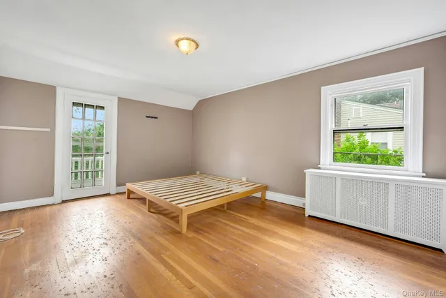 a view of room with window and hardwood floor