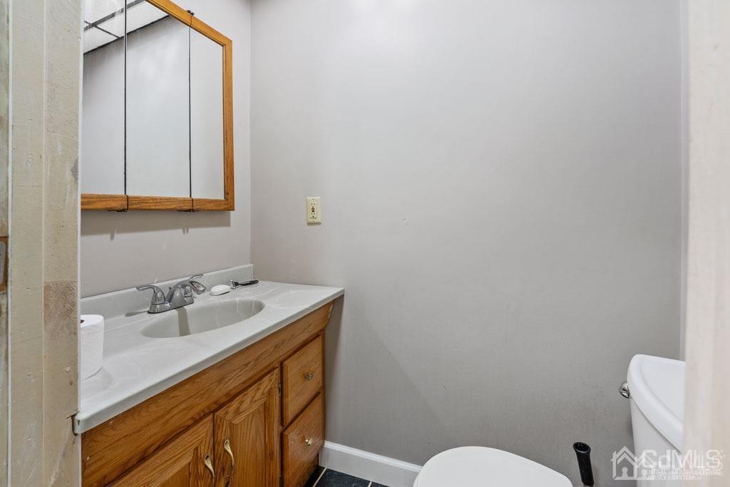70 County Road Cliffwood, NJ 07721 - Photo 17 of 28 a bathroom with a sink a toilet and mirror