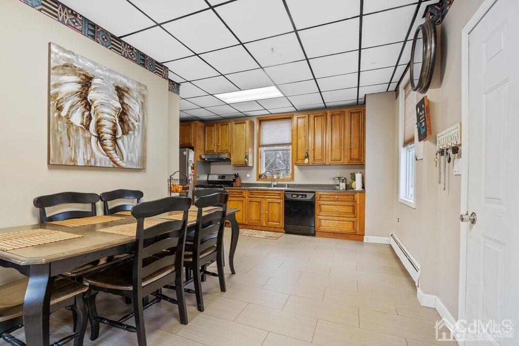70 County Road Cliffwood, NJ 07721 - Photo 5 of 28 a kitchen with a table chairs refrigerator and cabinets