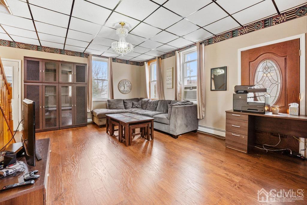 70 County Road Cliffwood, NJ 07721 - Photo 9 of 28 a living room with furniture a table and wooden floors
