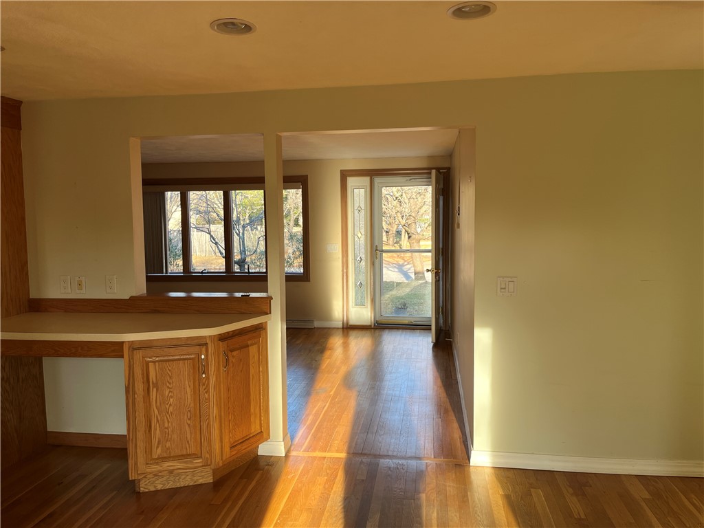19 Del Rio Court Warwick, RI 02818 - Photo 4 of 21 View from kitchen eat-in area toward front door through living room.