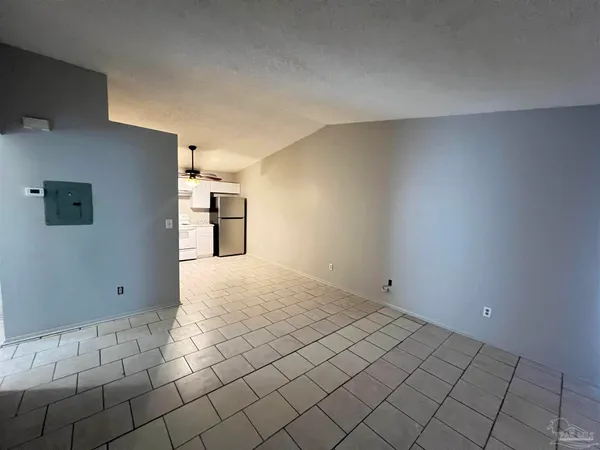 a view of a refrigerator and utility room