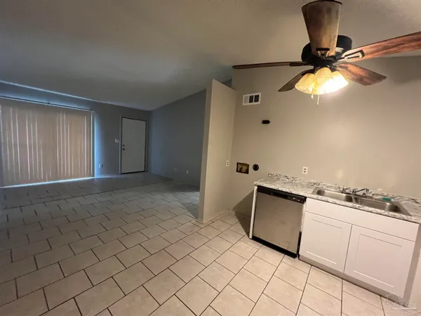 a kitchen with stainless steel appliances granite countertop a sink and a stove